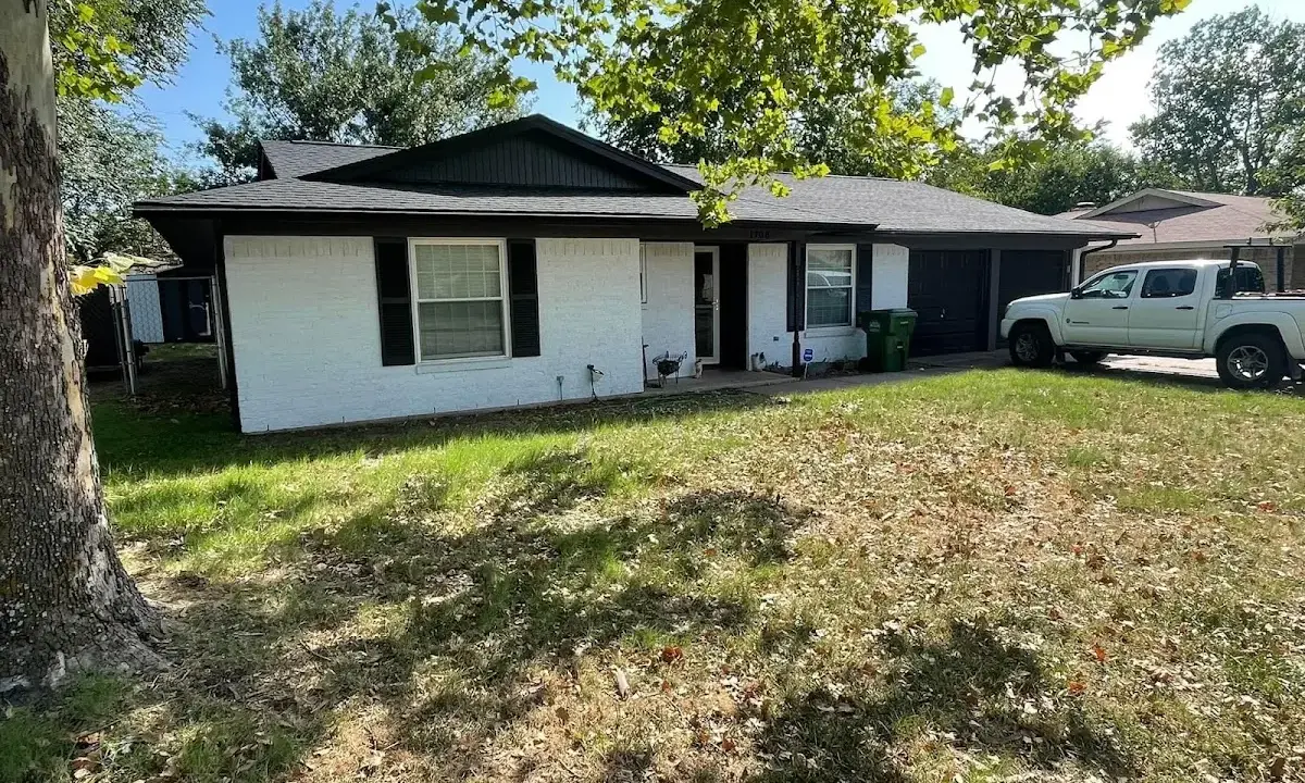 Professional roofing crew working on a residential roof in Indianola